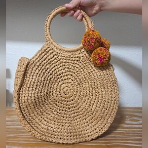 Chic Tan Woven Clutch with Pom Poms